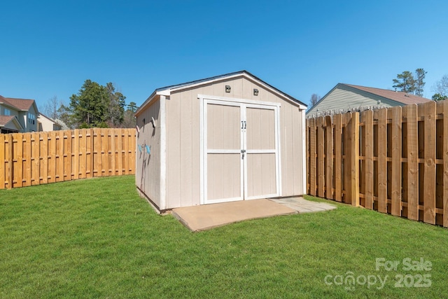 view of shed with a fenced backyard