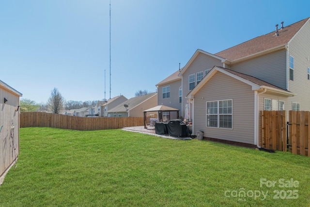 view of yard featuring a gazebo, a patio area, and a fenced backyard