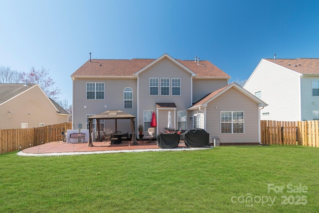 back of house with a patio area, a lawn, and a fenced backyard