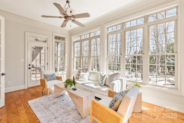 sunroom / solarium with a ceiling fan