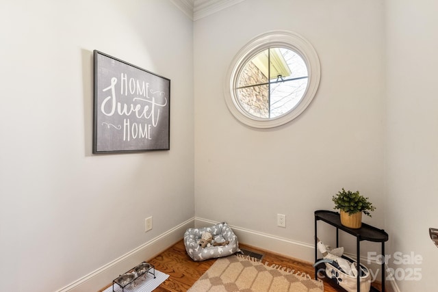 interior space featuring baseboards and wood finished floors