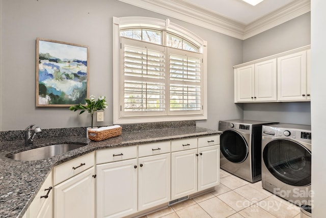 laundry room featuring light tile patterned flooring, a sink, ornamental molding, independent washer and dryer, and cabinet space