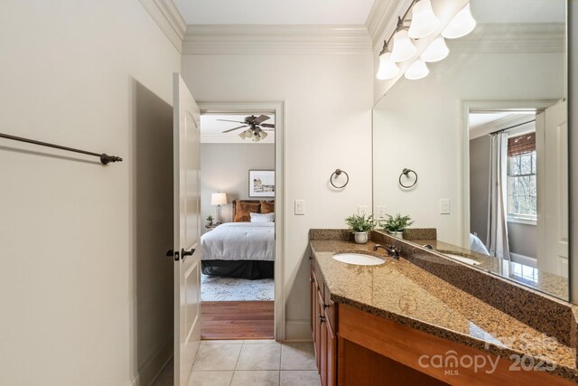 bathroom featuring ornamental molding, tile patterned flooring, vanity, and ensuite bath