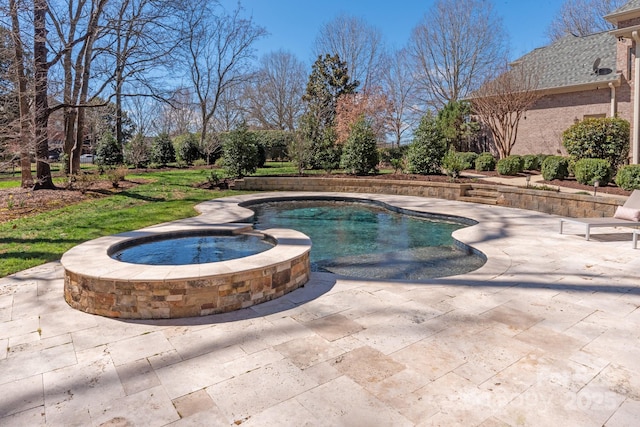 view of pool featuring a patio area and a pool with connected hot tub