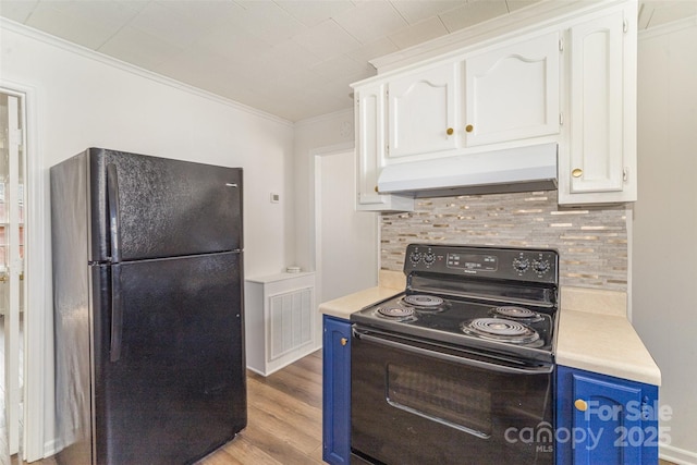 kitchen featuring blue cabinetry, light countertops, under cabinet range hood, and black appliances