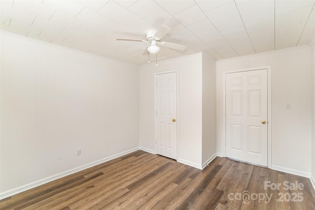 unfurnished bedroom with a ceiling fan, baseboards, wood finished floors, and ornamental molding