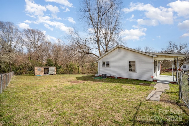 view of yard featuring fence private yard and an outbuilding