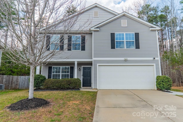 traditional-style house featuring driveway, an attached garage, fence, central air condition unit, and a front yard