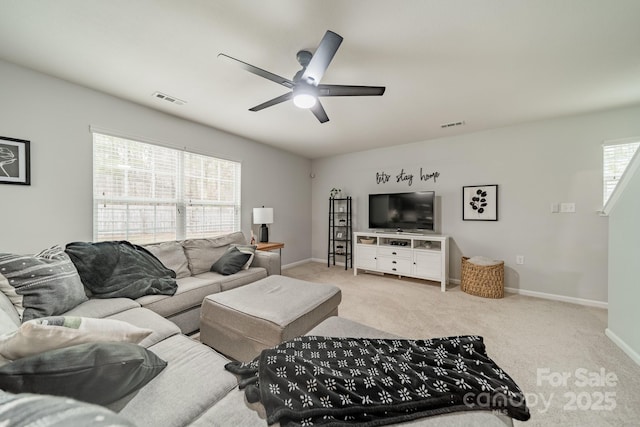 living room with a ceiling fan, visible vents, baseboards, and carpet flooring