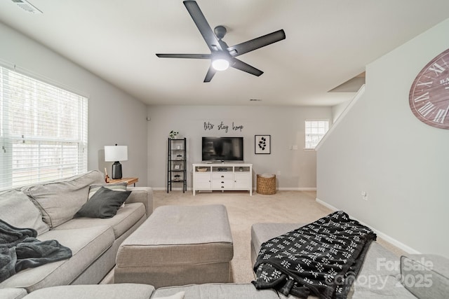 living room featuring light carpet, baseboards, visible vents, and a ceiling fan