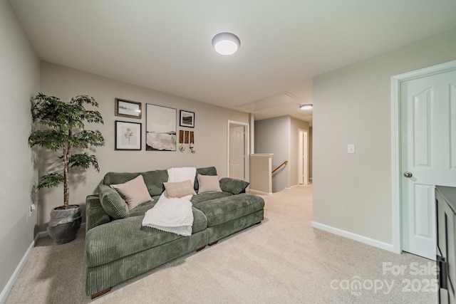 carpeted living area featuring baseboards