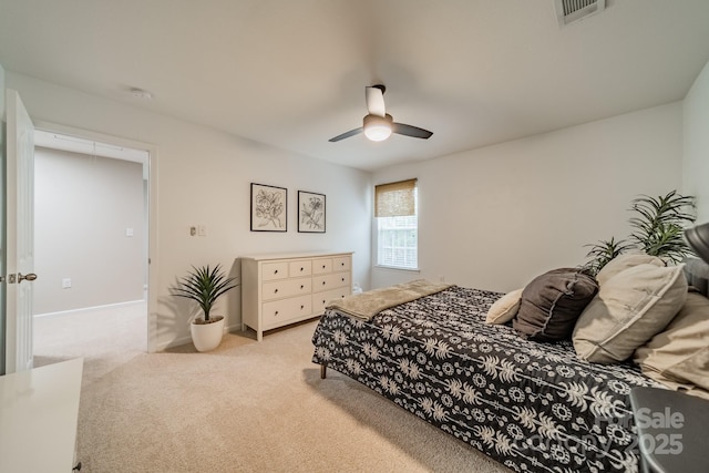 bedroom featuring light carpet, ceiling fan, visible vents, and baseboards