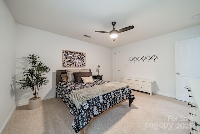 bedroom featuring baseboards, a ceiling fan, visible vents, and light colored carpet