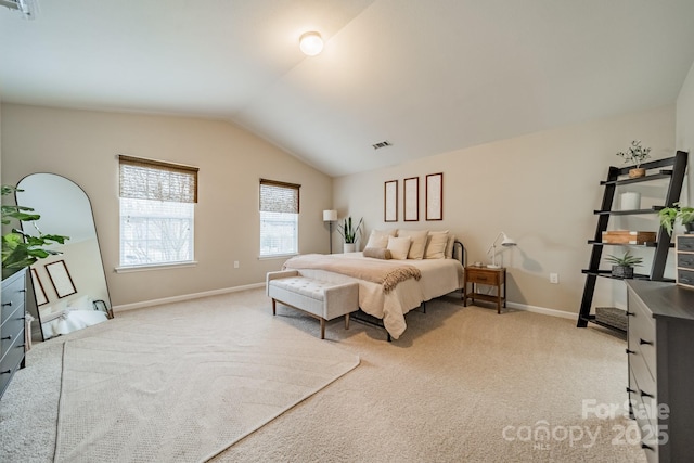 bedroom featuring lofted ceiling, baseboards, visible vents, and light colored carpet