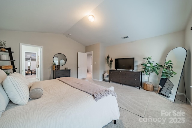 carpeted bedroom with visible vents, vaulted ceiling, and baseboards