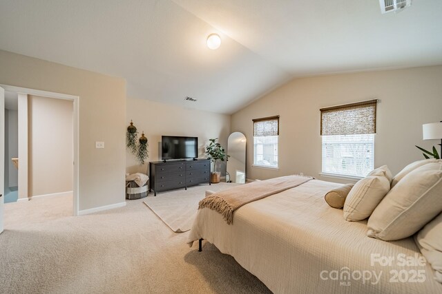 bedroom featuring vaulted ceiling, carpet flooring, visible vents, and baseboards