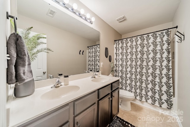 full bathroom with double vanity, visible vents, toilet, tile patterned floors, and a sink