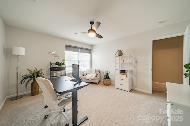 office area with carpet, baseboards, and a ceiling fan