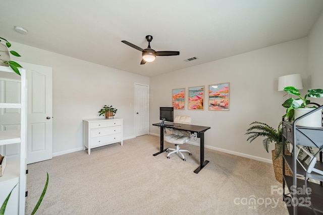 office space with light carpet, ceiling fan, visible vents, and baseboards