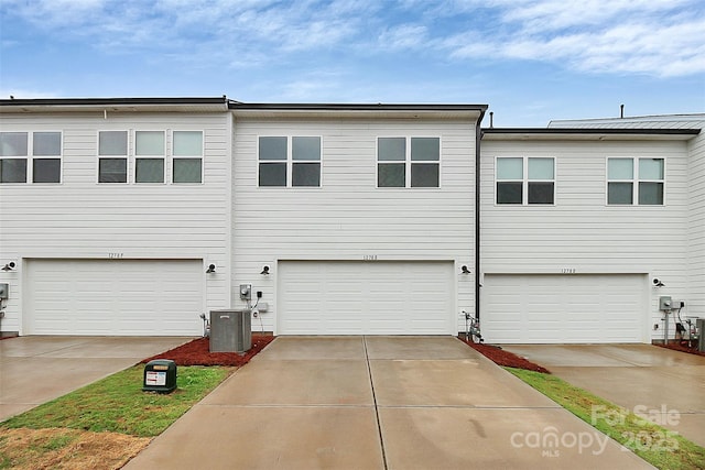 multi unit property featuring central air condition unit and concrete driveway