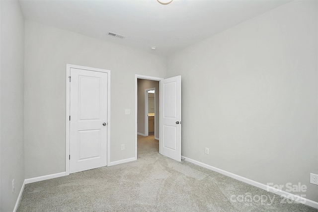 unfurnished bedroom with baseboards, visible vents, and light colored carpet