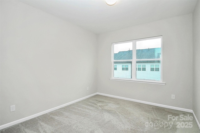 carpeted empty room with baseboards