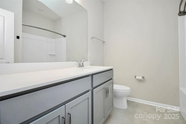 bathroom featuring toilet, baseboards,  shower combination, and vanity