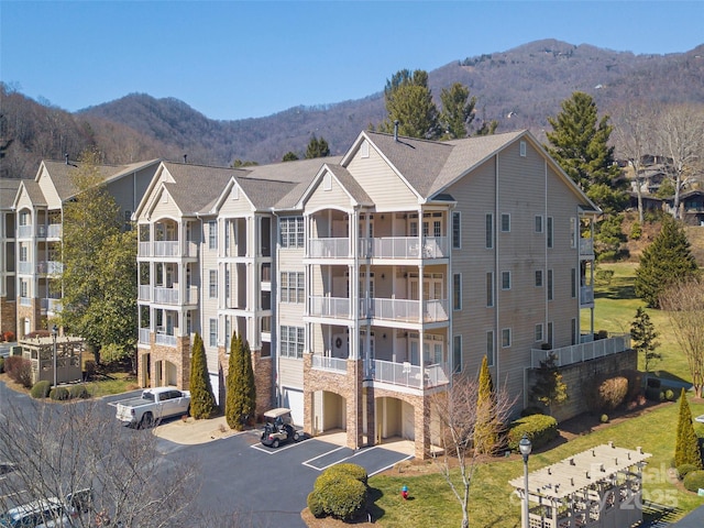 view of building exterior featuring a garage, driveway, and a mountain view