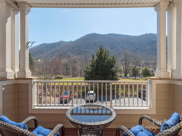 balcony with a mountain view and a wooded view