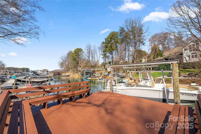 view of dock with boat lift and a water view