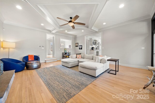 living room with recessed lighting, crown molding, and light wood finished floors
