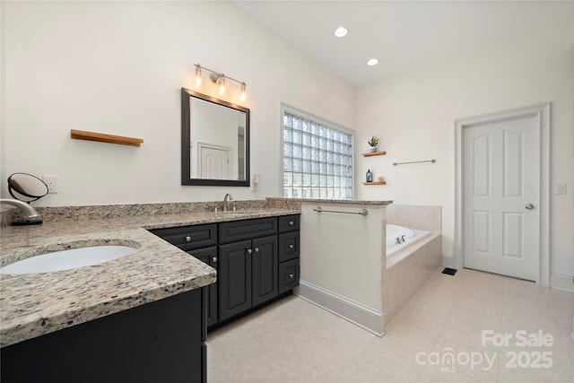 full bathroom featuring tile patterned flooring, a garden tub, recessed lighting, and vanity