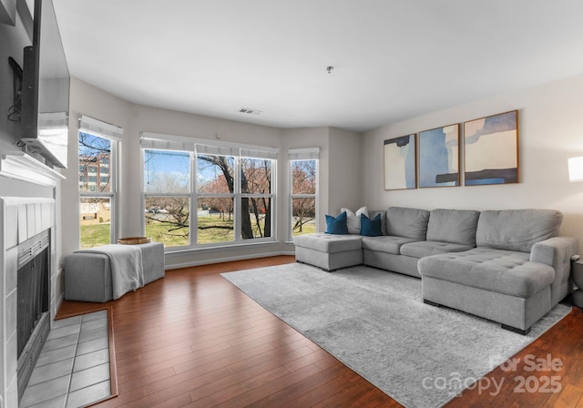 living area with hardwood / wood-style flooring and visible vents