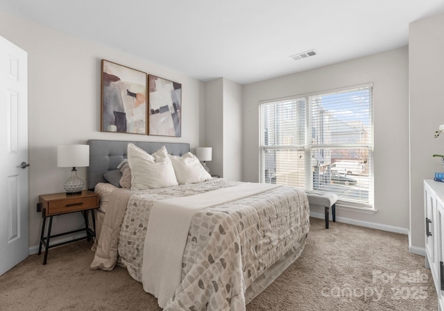 bedroom featuring visible vents, baseboards, and light colored carpet