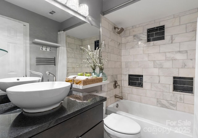 bathroom featuring visible vents, toilet, vanity, and shower / bathtub combination with curtain