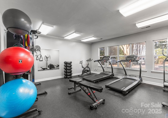 exercise room featuring visible vents and baseboards