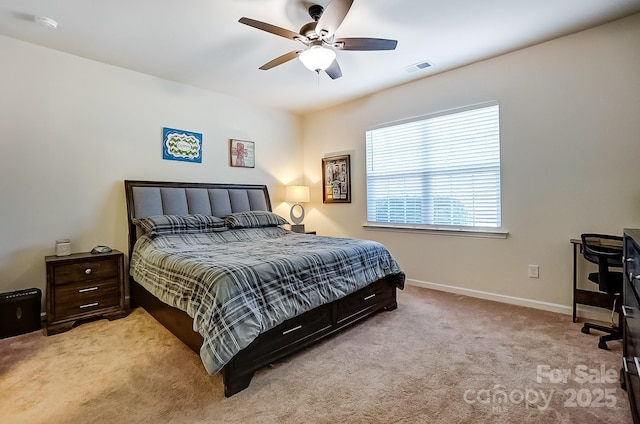 carpeted bedroom featuring visible vents, baseboards, and ceiling fan