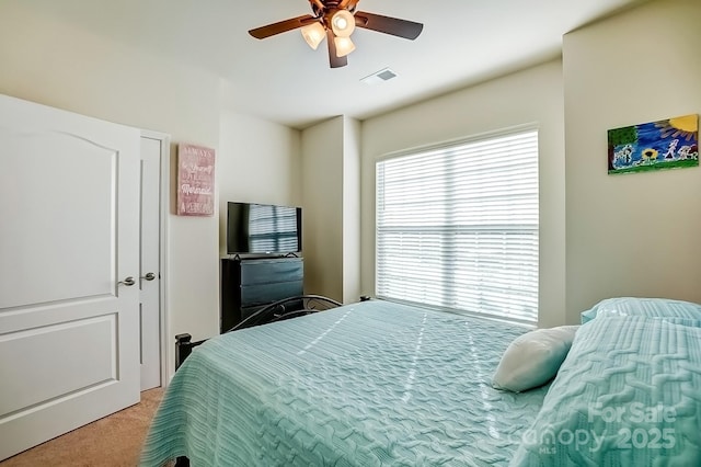 bedroom featuring a ceiling fan, carpet, and visible vents