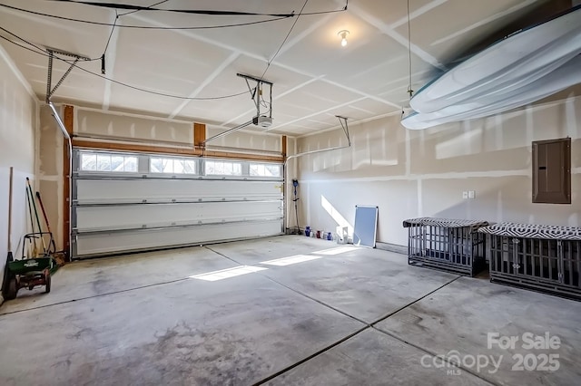 garage with a garage door opener and electric panel