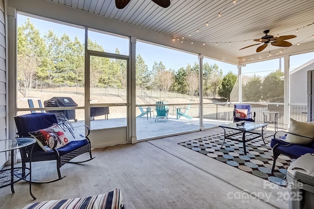 sunroom / solarium featuring a ceiling fan and a healthy amount of sunlight