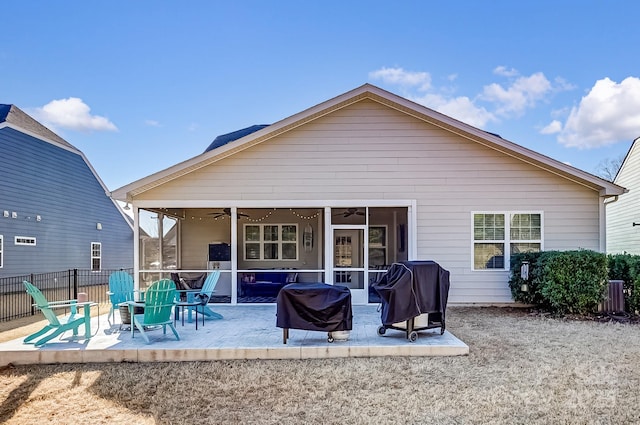 back of property featuring ceiling fan, a patio area, fence, and a sunroom