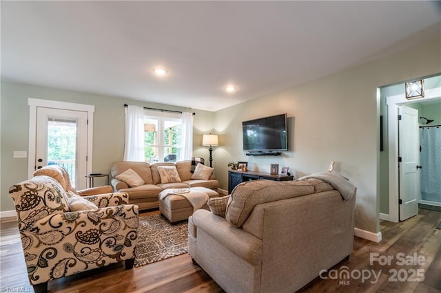 living area featuring baseboards, wood finished floors, and recessed lighting