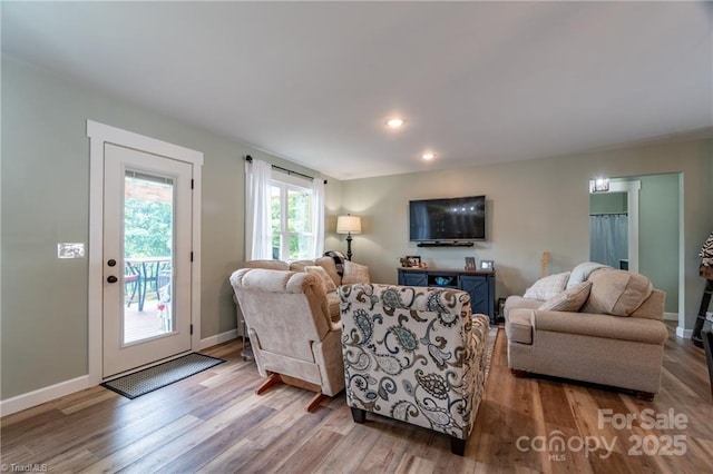 living room with recessed lighting, wood finished floors, and baseboards