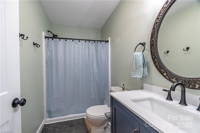 bathroom featuring a shower with shower curtain, vanity, toilet, and baseboards