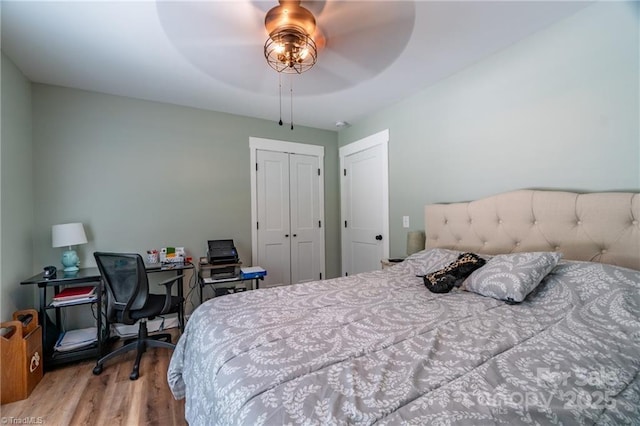 bedroom with a ceiling fan, a closet, and wood finished floors