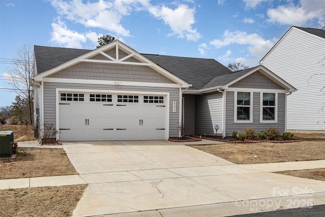 view of front of home with a garage, concrete driveway, and central AC unit