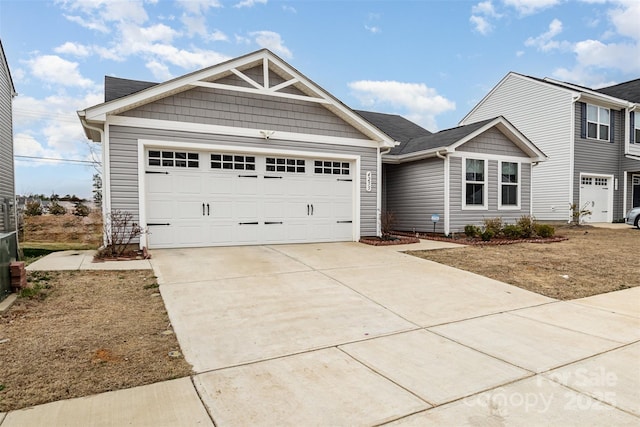 view of front facade with a garage and concrete driveway