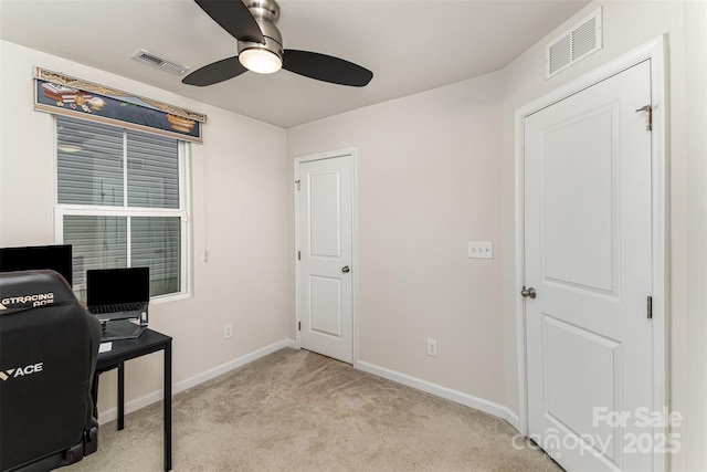 carpeted office featuring visible vents, ceiling fan, and baseboards