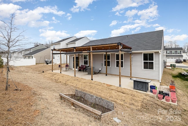 rear view of property featuring a garden, a patio area, fence, and central AC unit