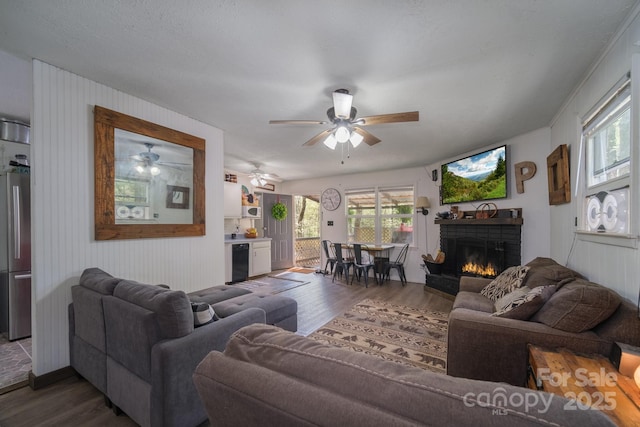 living room with a fireplace and wood finished floors